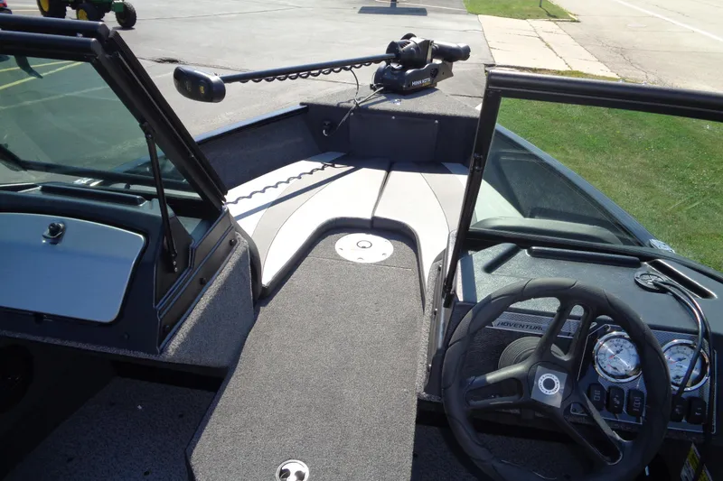 Slide: The Image of 2025 Lund 1775 Adventure Sport boat interior with steering wheel and control panel. - 7