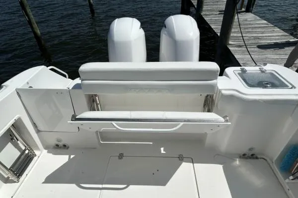 Slide: The Image of 2019 Edgewater 262 CX boat stern with dual engines and dockside view. - 10