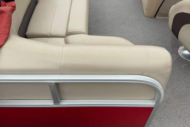 Slide: The Image of 2017 Sun Tracker Bass Buggy 18 DLX beige seating with red paneling. - 10