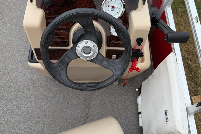 Slide: The Image of 2017 Sun Tracker Bass Buggy 18 DLX steering console with gauges and controls. - 12