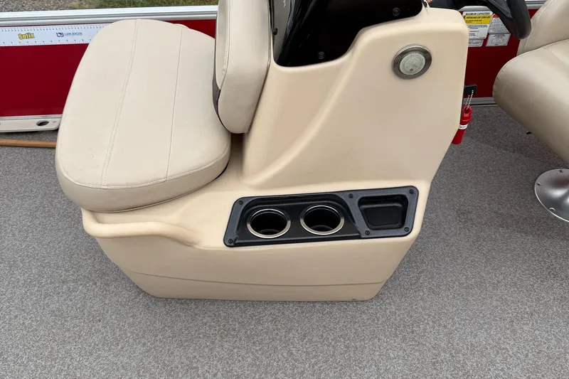 Slide: The Image of 2017 Sun Tracker Bass Buggy 18 DLX boat interior with beige seating and cup holders. - 14