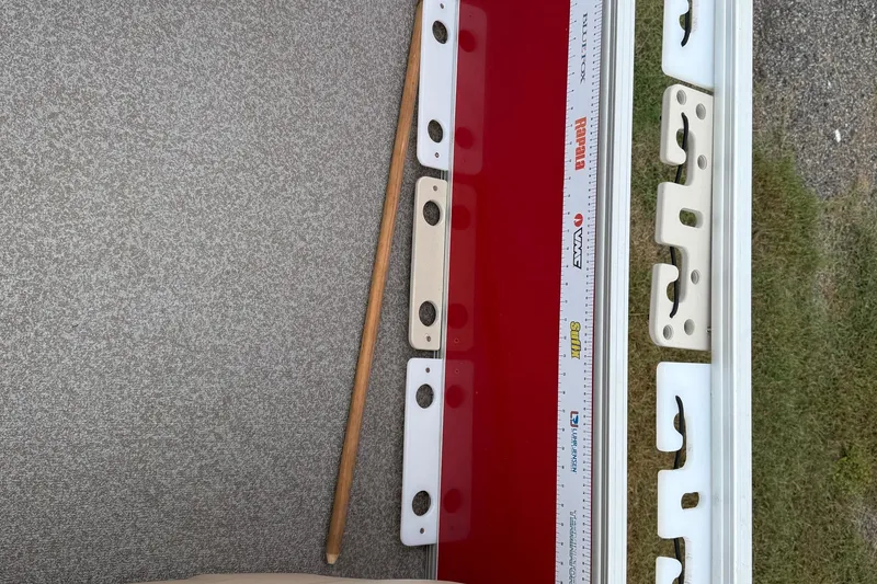 Slide: The Image of 2017 Sun Tracker Bass Buggy 18 DLX interior with measuring ruler and rod holders. - 16