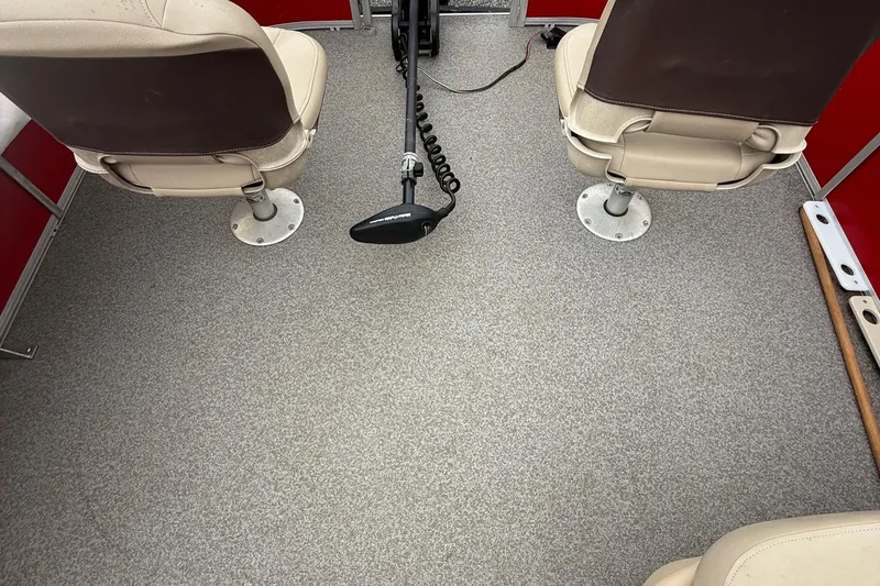 Slide: The Image of Interior of 2017 Sun Tracker Bass Buggy 18 DLX with two swivel seats and carpeted floor. - 18