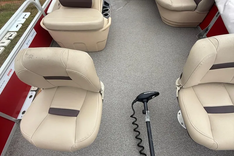 Slide: The Image of 2017 Sun Tracker Bass Buggy 18 DLX interior with beige seats and trolling motor. - 19