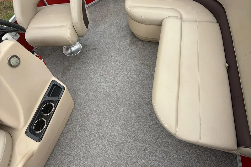 Slide: The Image of 2017 Sun Tracker Bass Buggy 18 DLX interior with beige seating and cup holders. - 3