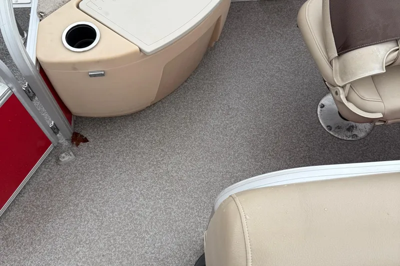 Slide: The Image of 2017 Sun Tracker Bass Buggy 18 DLX interior with beige seating and carpeted floor. - 7