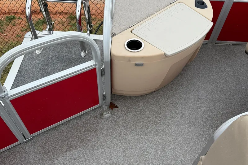 Slide: The Image of 2017 Sun Tracker Bass Buggy 18 DLX interior with red paneling and storage compartment. - 8