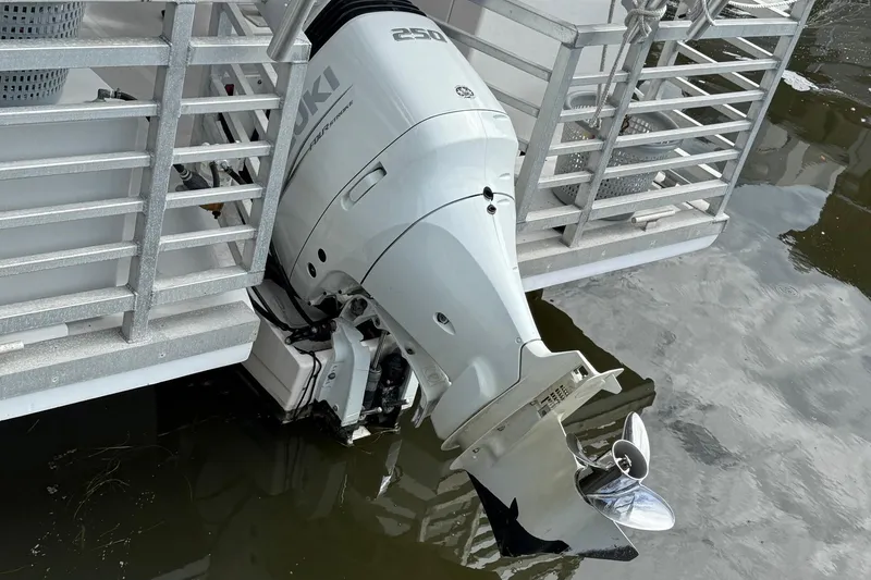 Slide: The Image of 2022 Guthrie Boatworks A&M Custom Pontoon with Suzuki outboard motor in water. - 11