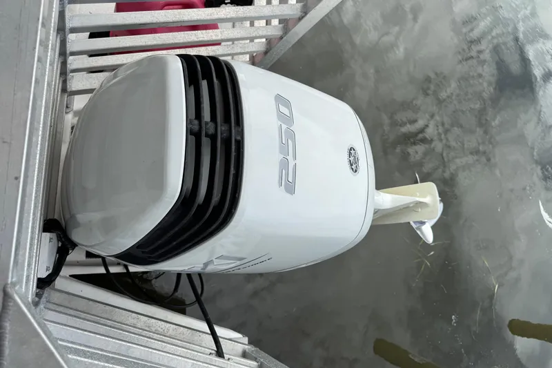 Slide: The Image of Outboard motor on 2022 Guthrie Boatworks A&M Custom Pontoon, docked on water. - 20