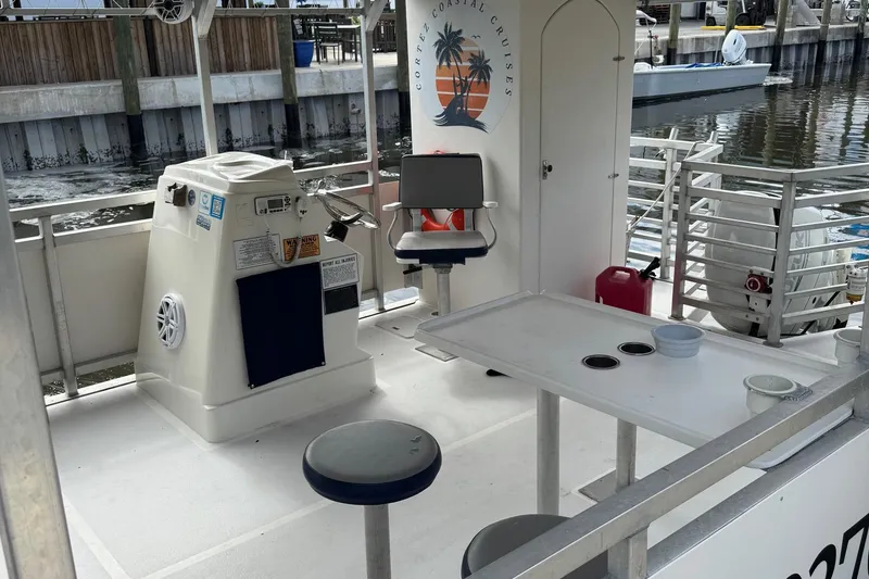 Slide: The Image of 2022 Guthrie Boatworks A&M Custom Pontoon interior with seating and control panel. - 22