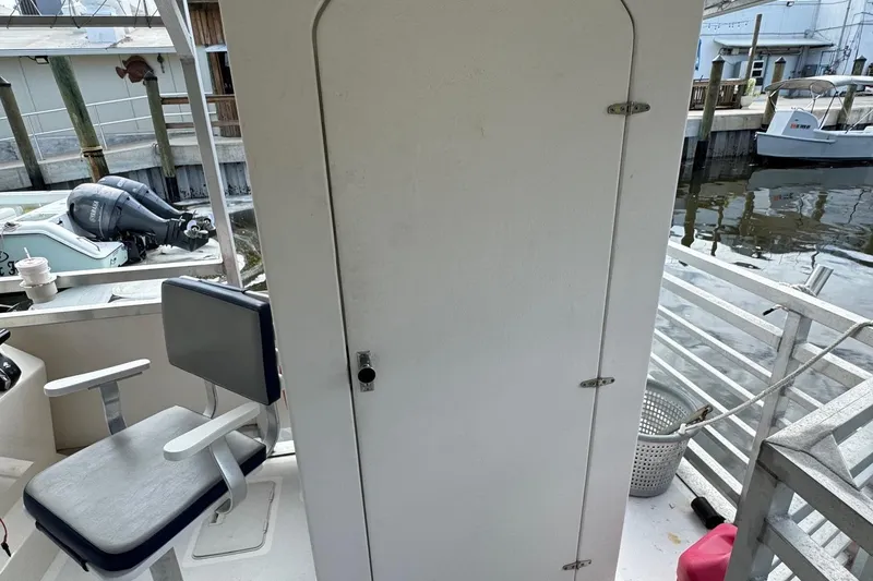 Slide: The Image of 2022 Guthrie Boatworks A&M Custom Pontoon interior with seating and dock view. - 23