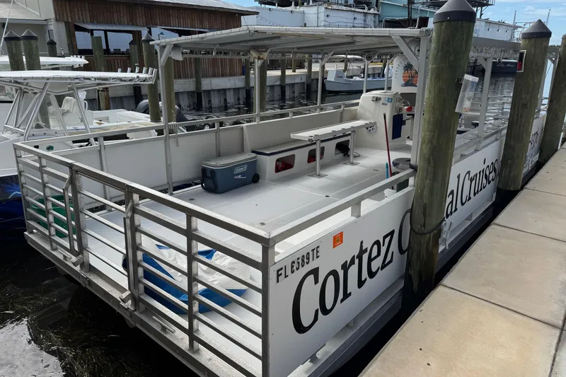 Slide: The Image of 2022 Guthrie Boatworks A&M Custom Pontoon docked, featuring "Cortez Coastal Cruises" branding. - 3