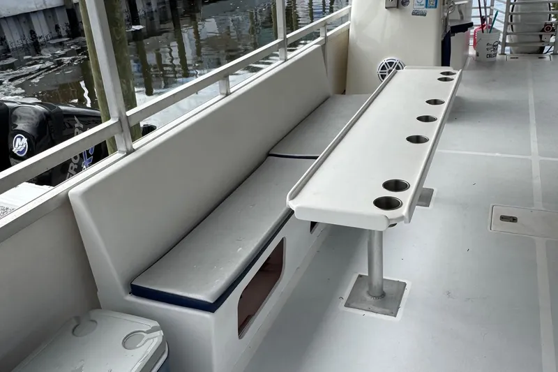 Slide: The Image of 2022 Guthrie Boatworks A&M Custom Pontoon interior with seating and cup holders. - 31