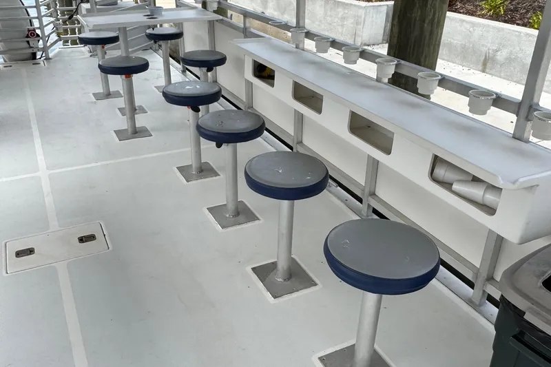 Slide: The Image of 2022 Guthrie Boatworks A&M Custom Pontoon interior with seating and storage compartments. - 34