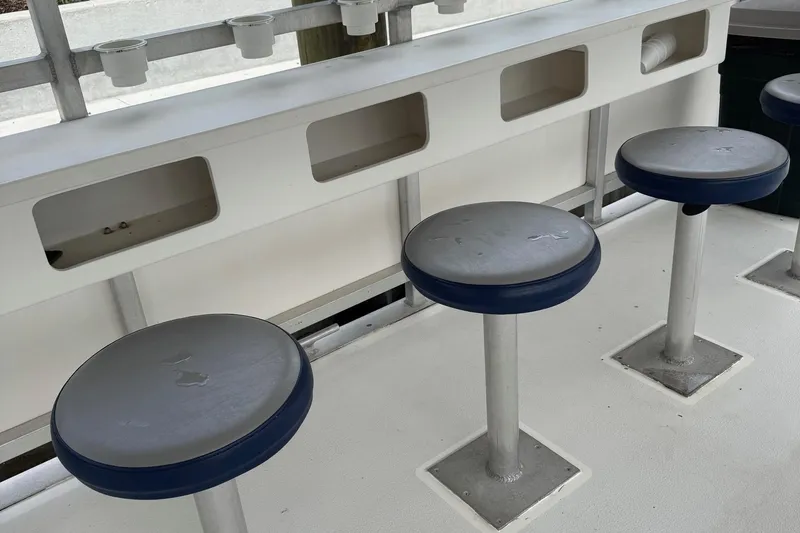 Slide: The Image of Interior seating of 2022 Guthrie Boatworks A&M Custom Pontoon with blue cushioned stools. - 36
