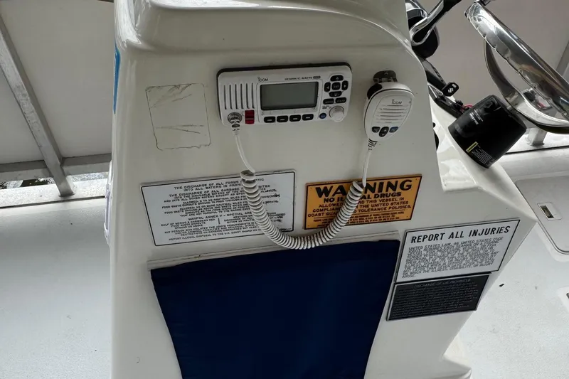 Slide: The Image of Control panel of 2022 Guthrie Boatworks A&M Custom Pontoon with radio and safety warnings. - 40