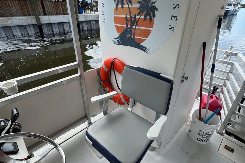 Slide: The Image of 2022 Guthrie Boatworks A&M Custom Pontoon interior with seat, life preserver, and nautical decor. - 41