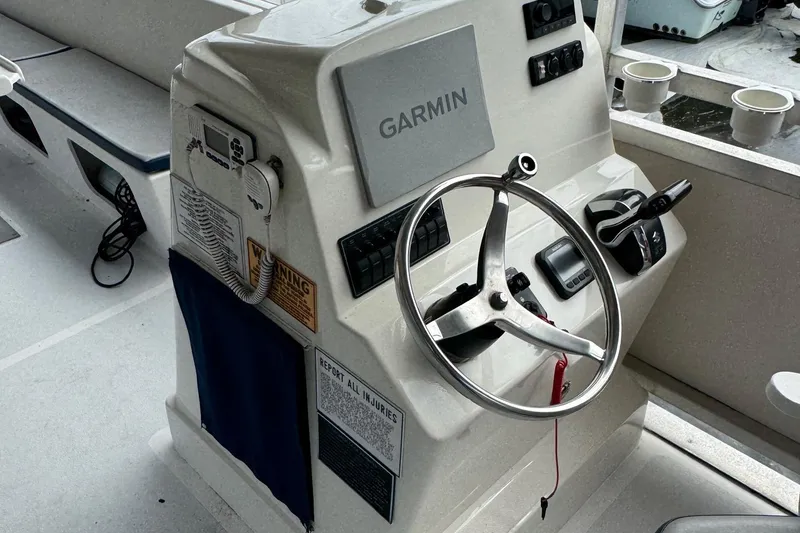 Slide: The Image of 2022 Guthrie Boatworks A&M Custom Pontoon helm with Garmin navigation system and steering wheel. - 43