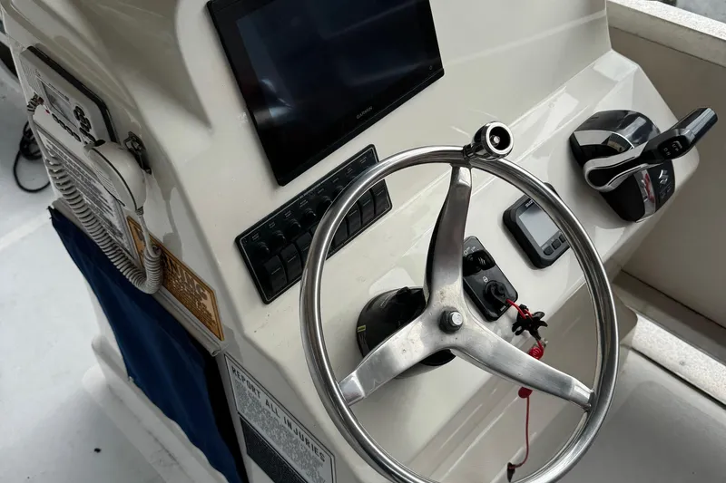 Slide: The Image of 2022 Guthrie Boatworks A&M Custom Pontoon steering console with controls and display. - 54