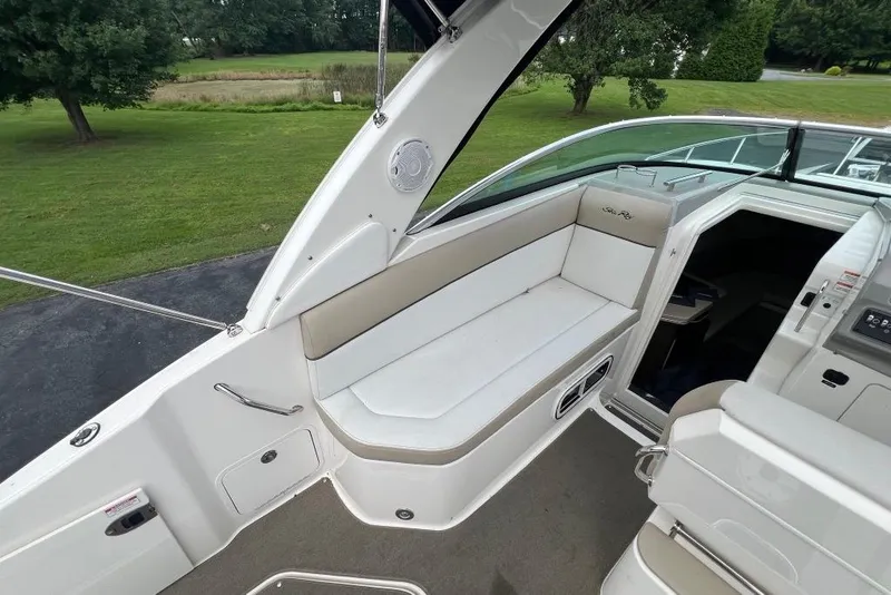 Slide: The Image of 2015 Sea Ray 260 Sundancer boat interior with seating and cabin entrance. - 10