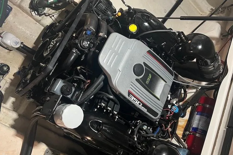 Slide: The Image of Engine of a 2015 Sea Ray 260 Sundancer boat, showcasing detailed components. - 14