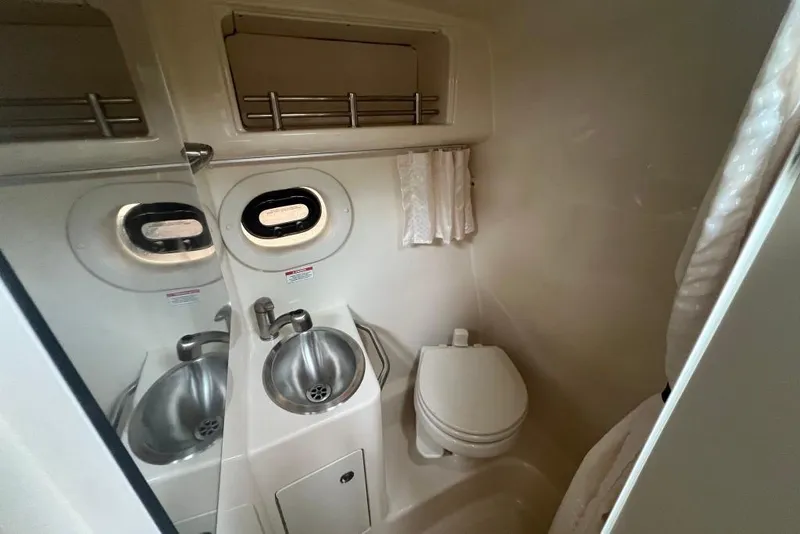 Slide: The Image of Compact bathroom in 2015 Sea Ray 260 Sundancer boat with sink and toilet. - 17