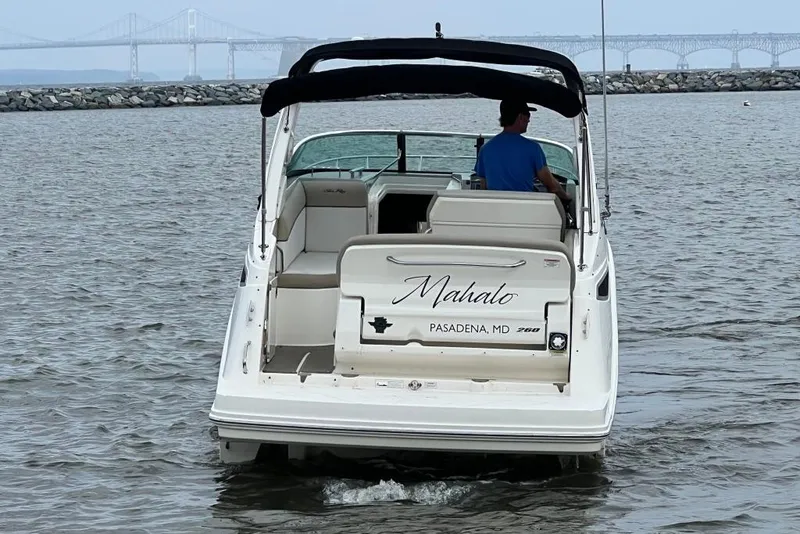 Slide: The Image of 2015 Sea Ray 260 Sundancer boat on water, bridge in background. - 3
