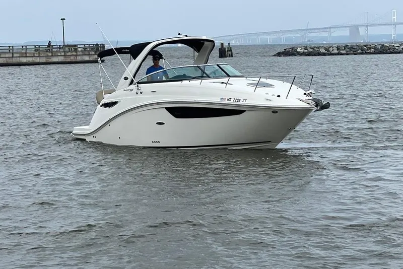 Slide: The Image of 2015 Sea Ray 260 Sundancer boat cruising on a calm waterway. - 5