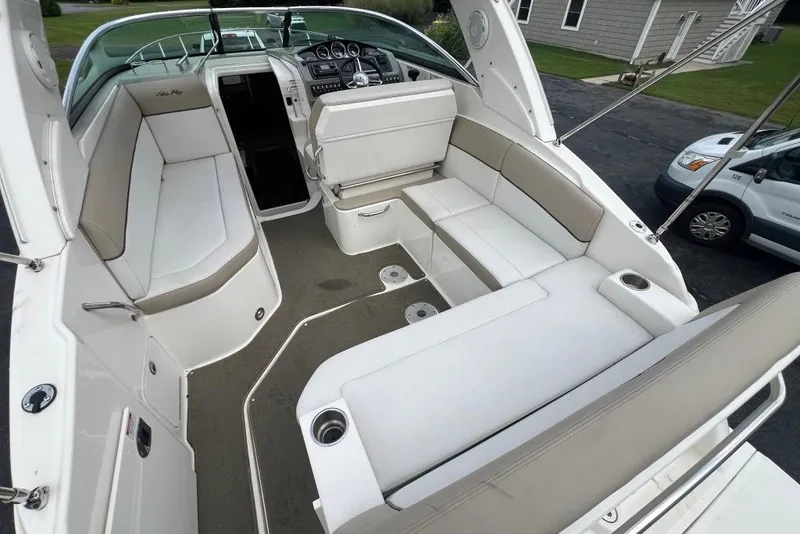 Slide: The Image of 2015 Sea Ray 260 Sundancer boat interior with spacious seating and modern dashboard. - 9