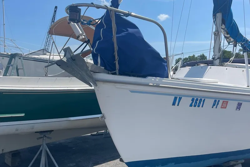 Slide: The Image of Catalina 22 sailboat with anchor, docked, displaying registration number NY 2681 PF. - 13