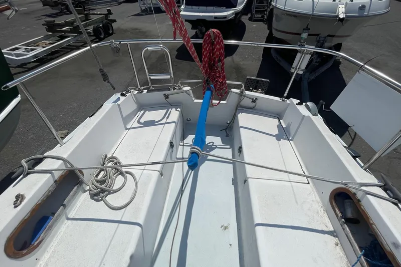 Slide: The Image of Catalina 22 sailboat cockpit with ropes and railing, parked on a trailer. - 2