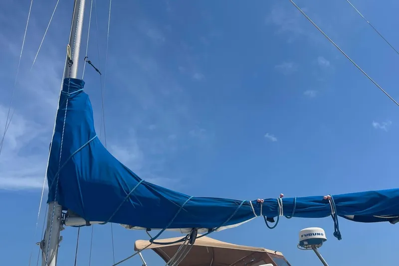 Slide: The Image of Catalina 22 sailboat mast with blue sail cover against clear sky. - 3