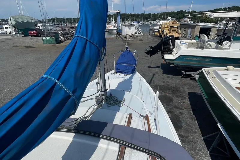 Slide: The Image of Catalina 22 sailboat with blue sail cover docked at a marina. - 5