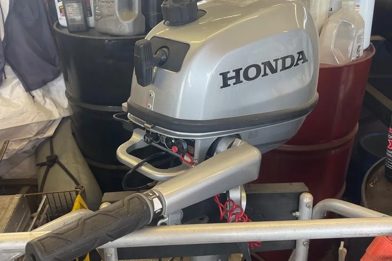 Slide: The Image of Honda outboard motor in a workshop, suitable for Catalina 22 sailboat. - 8