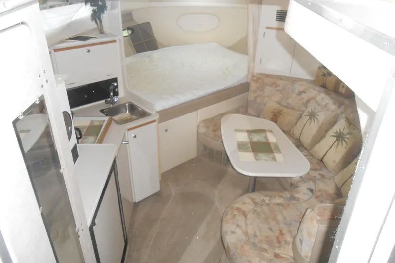 Slide: The Image of 1999 Bayliner 3055 Ciera interior with kitchenette, seating area, and bed. - 10