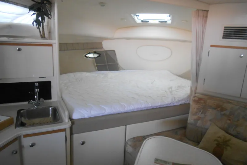 Slide: The Image of 1999 Bayliner 3055 Ciera cabin interior with bed, sink, and seating area. - 11
