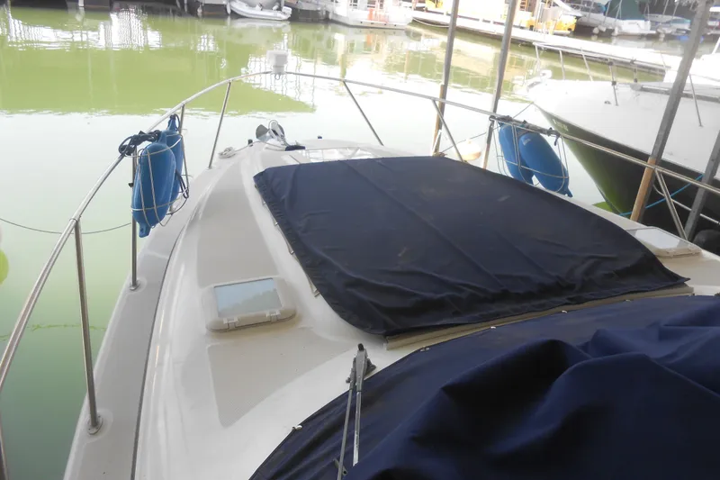 Slide: The Image of 1999 Bayliner 3055 Ciera boat docked, covered deck, marina background. - 3