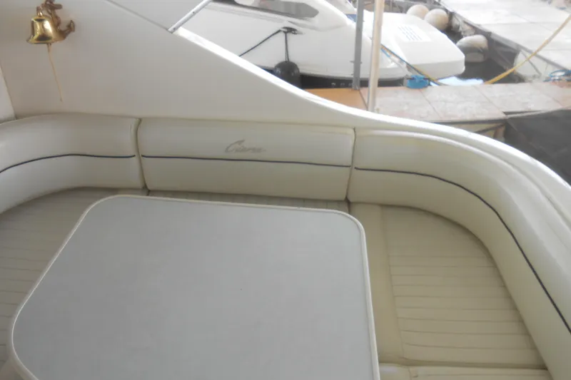 Slide: The Image of 1999 Bayliner 3055 Ciera boat interior with cushioned seating and table. - 6