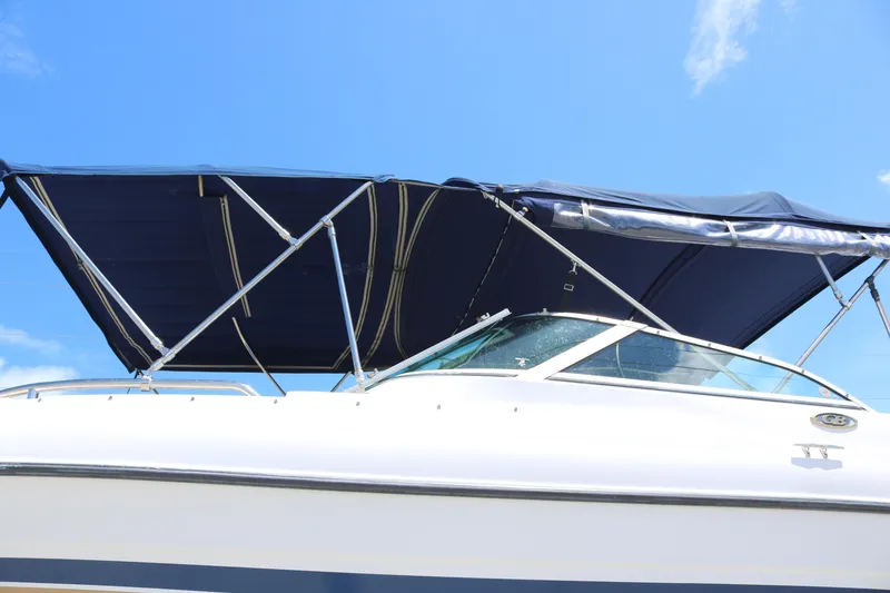 Slide: The Image of 2007 Glacier Bay 2240 boat with blue canopy against clear sky. - 4