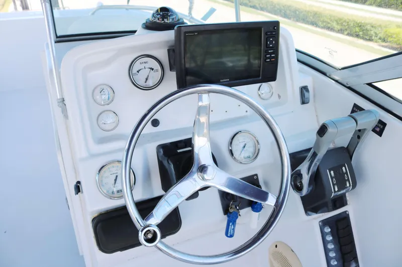 Slide: The Image of Control panel of 2007 Glacier Bay 2240 boat with steering wheel and gauges. - 5
