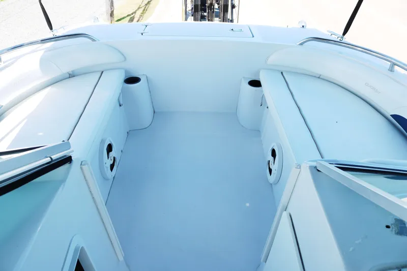 Slide: The Image of 2007 Glacier Bay 2240 boat interior with white seating and cup holders. - 7
