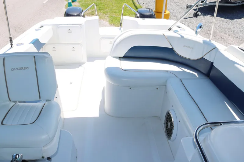 Slide: The Image of 2007 Glacier Bay 2240 boat interior with white seating and storage compartments. - 9