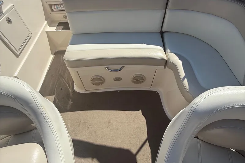 Slide: The Image of 2005 Bryant 214 boat interior with white leather seating and carpeted floor. - 11