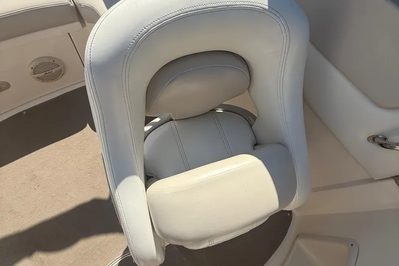 Slide: The Image of White leather boat seat in a 2005 Bryant 214, featuring elegant stitching. - 12