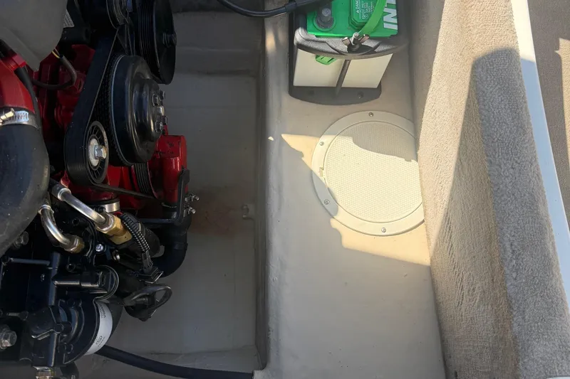 Slide: The Image of Engine compartment of a 2005 Bryant 214 boat with visible battery and components. - 18