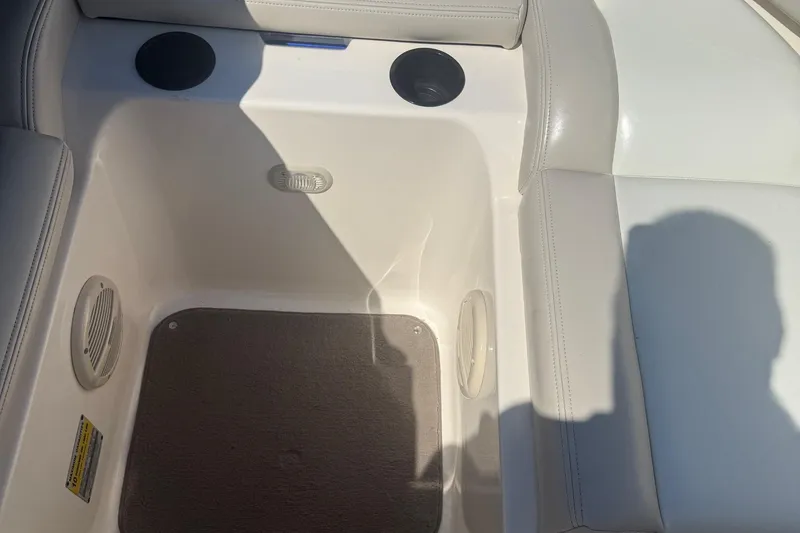 Slide: The Image of Interior of a 2005 Bryant 214 boat, featuring seating and speaker details. - 20