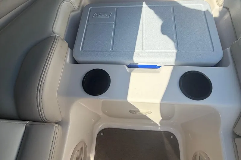 Slide: The Image of Interior of a 2005 Bryant 214 boat featuring seating and a Coleman cooler. - 21