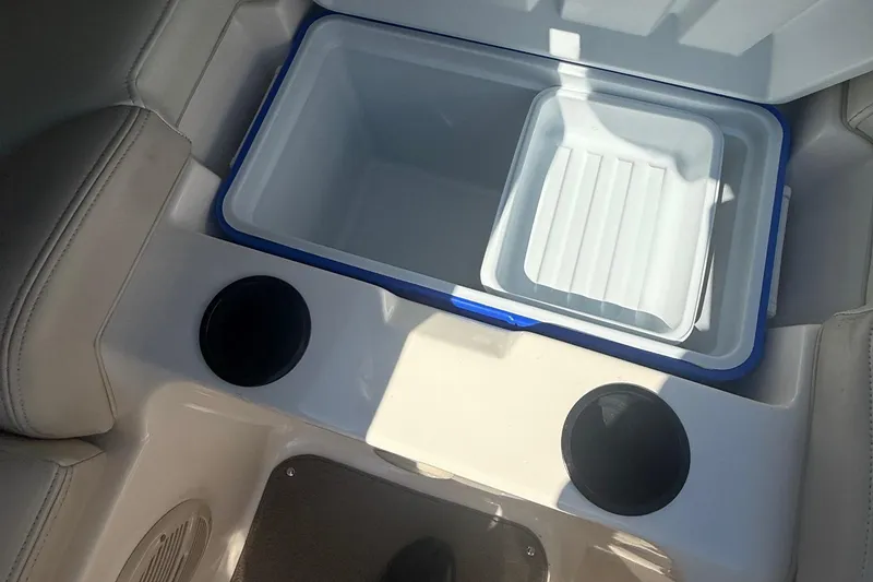 Slide: The Image of Open cooler with cup holders on a 2005 Bryant 214 boat interior. - 22