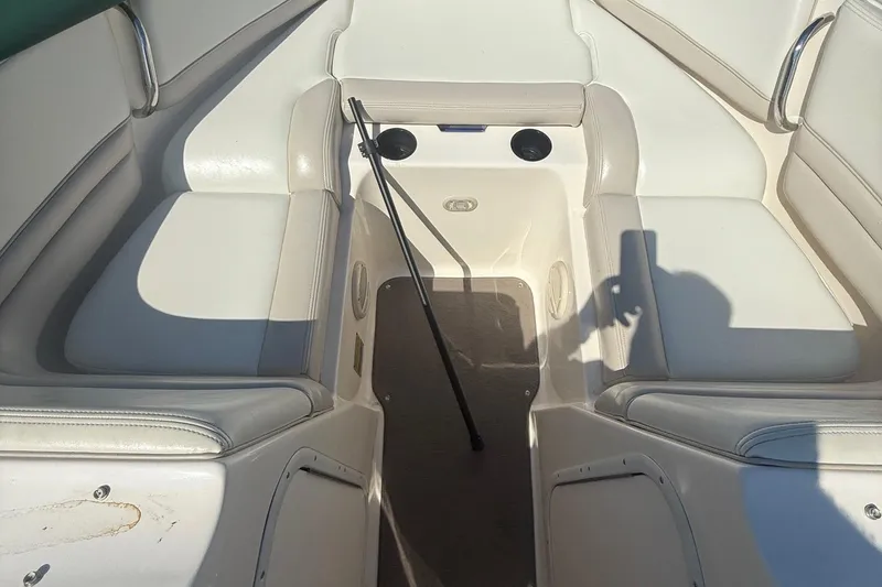 Slide: The Image of Interior of a 2005 Bryant 214 boat with white seating and shadow. - 24