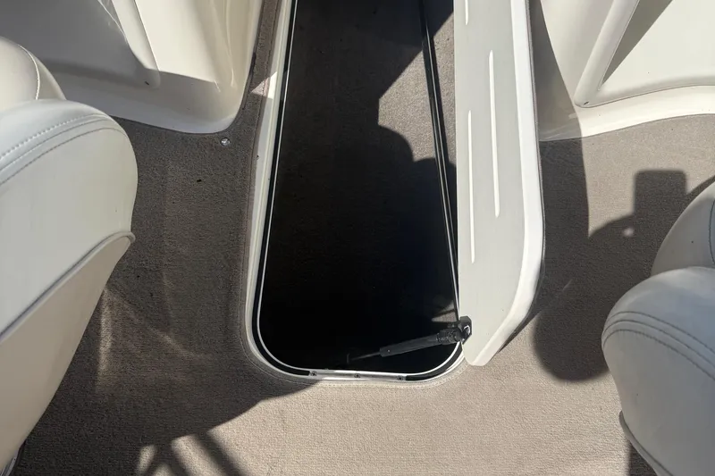 Slide: The Image of Open storage compartment on 2005 Bryant 214 boat with beige interior. - 27